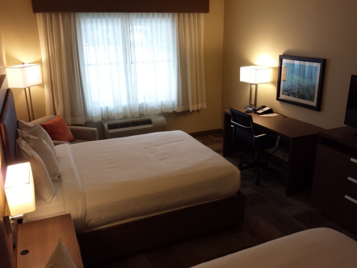 Room with two queen beds, includes desk, flatscreen TV